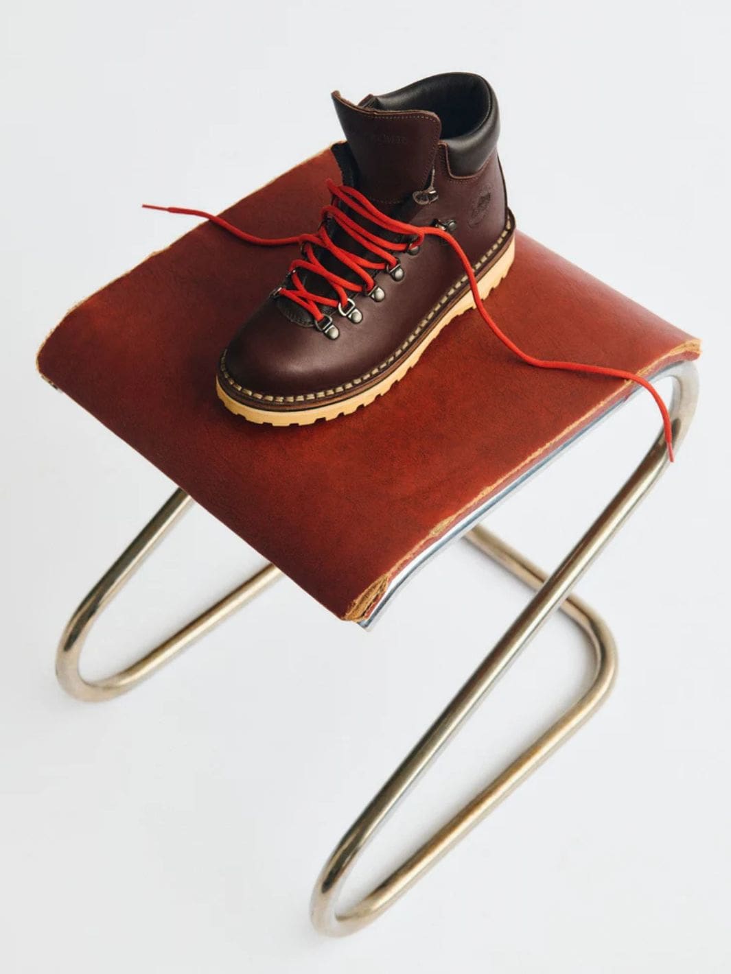 Diemme Roccia Vet Shearling Mogano Brown fjellstøvel med røde lisser på brun skinnkrakk.